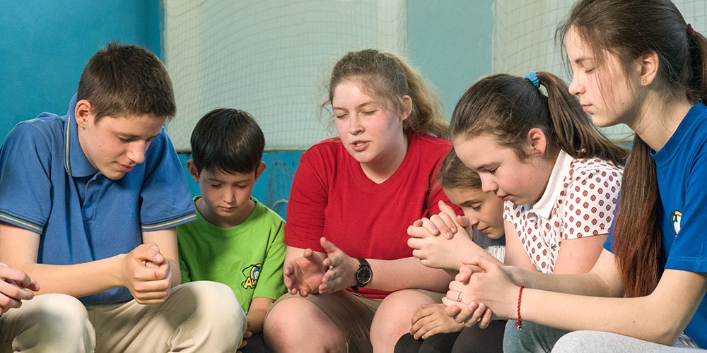 Praying at an Awana club in Ukraine